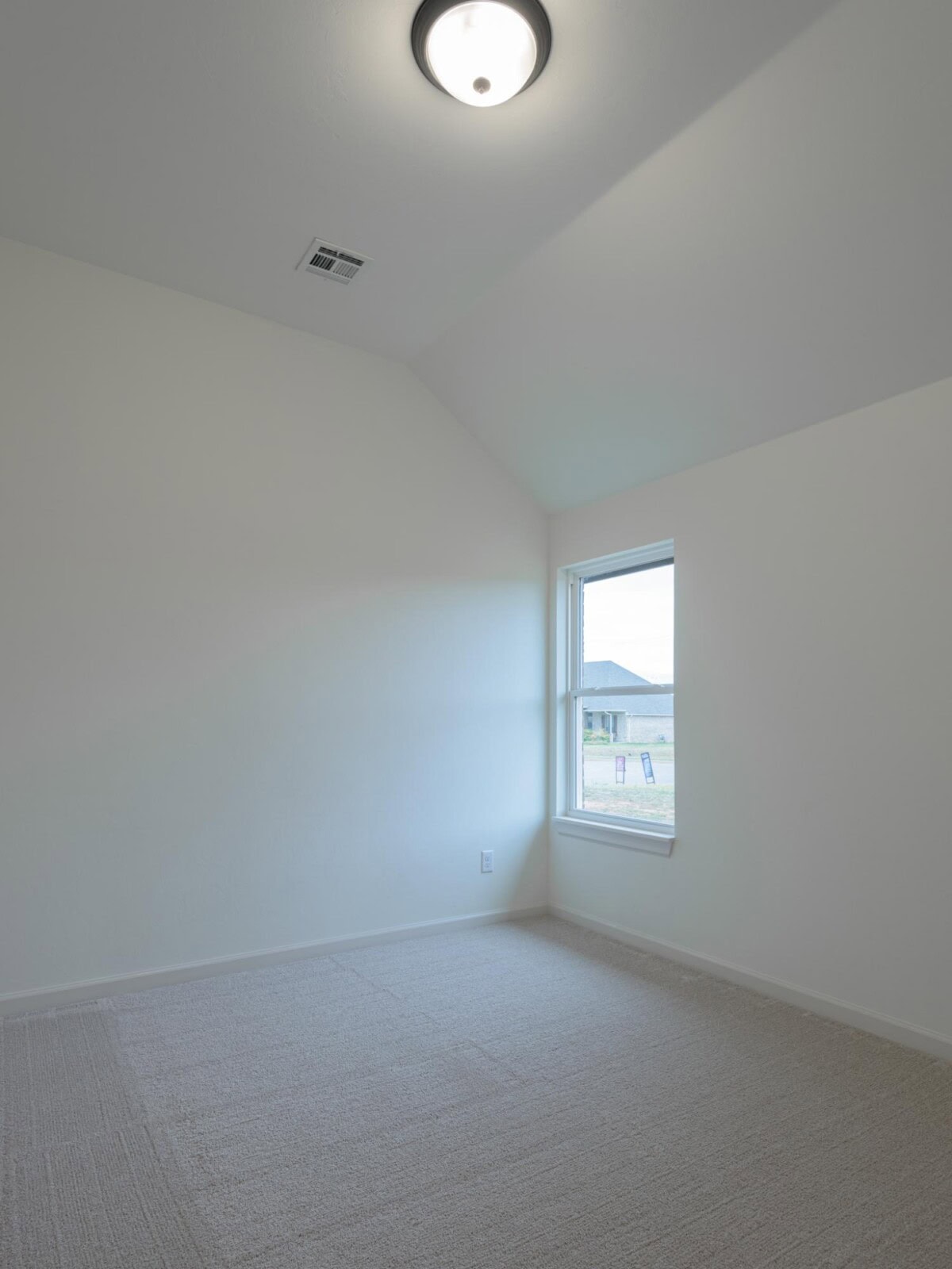 A empty room with a light and a window