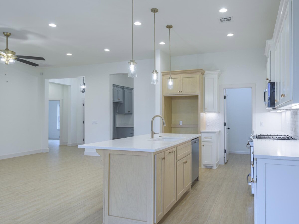 A kitchen with a ceiling fan and a refrigerator