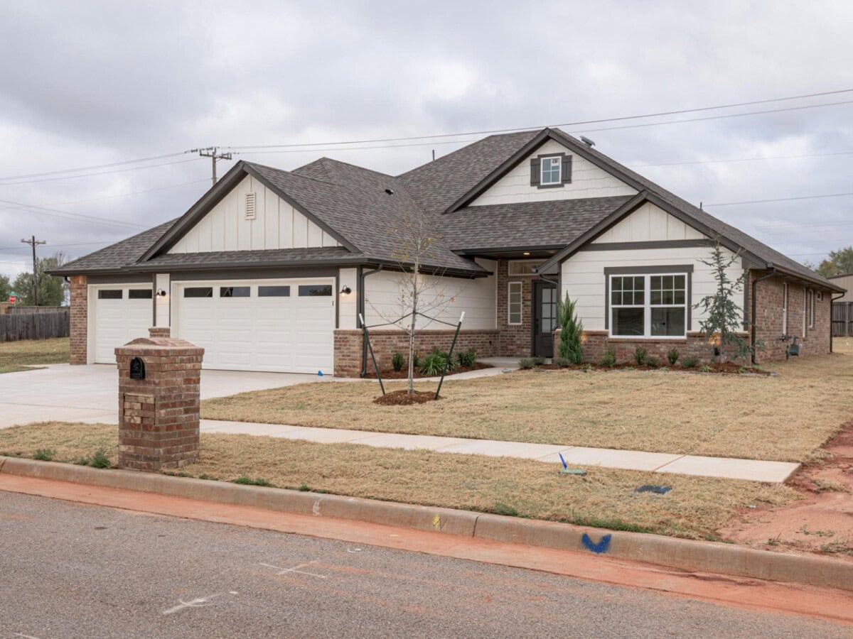 A home with a large driveway and a large garage