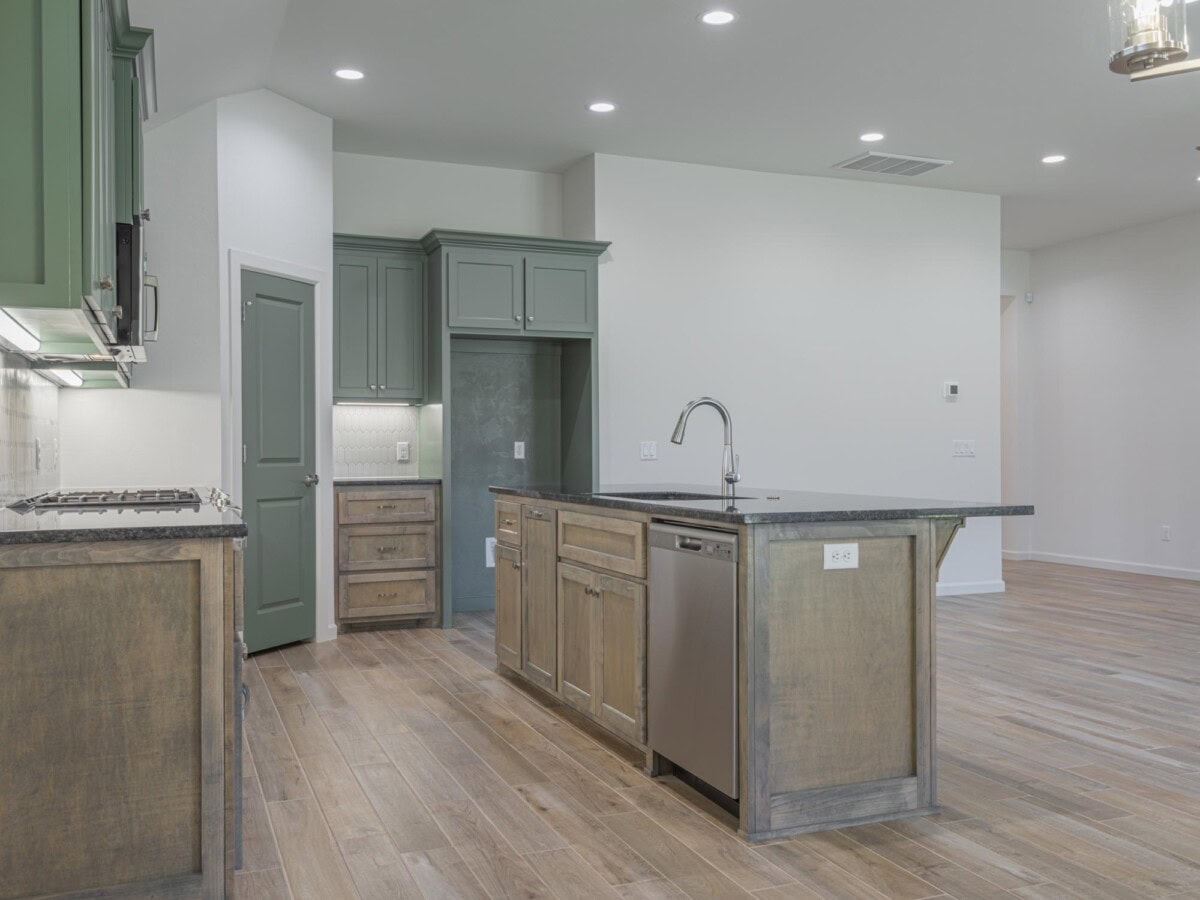 A kitchen with a sink and a stove top