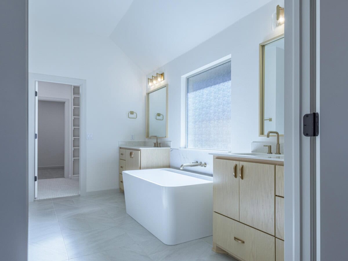A bathroom with a white tub and a sink