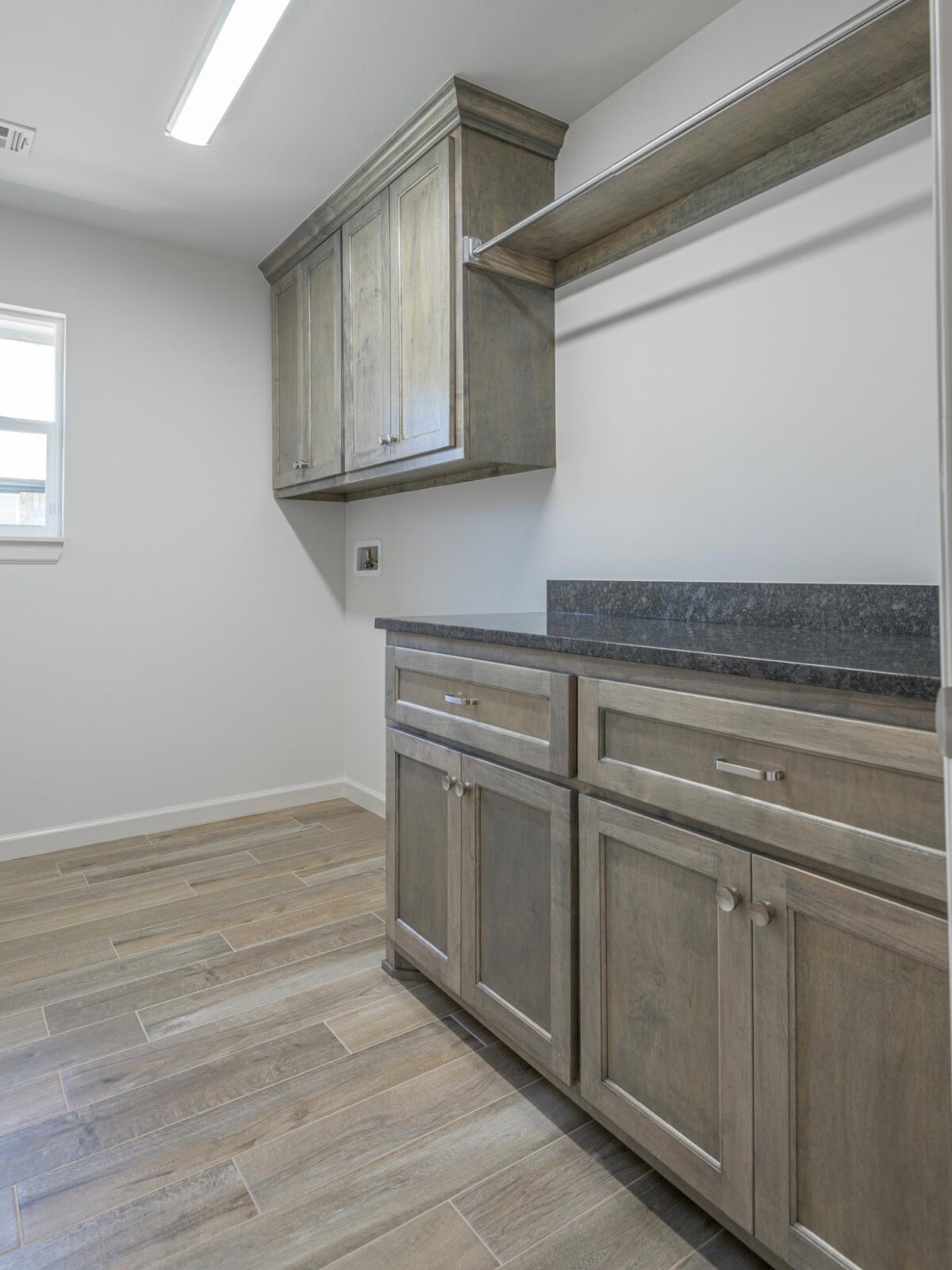 A kitchen with wood cabinets and a sink