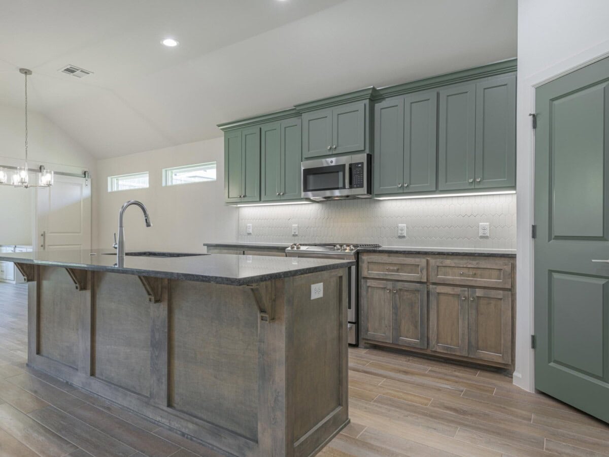 A kitchen with a center island and wooden floors