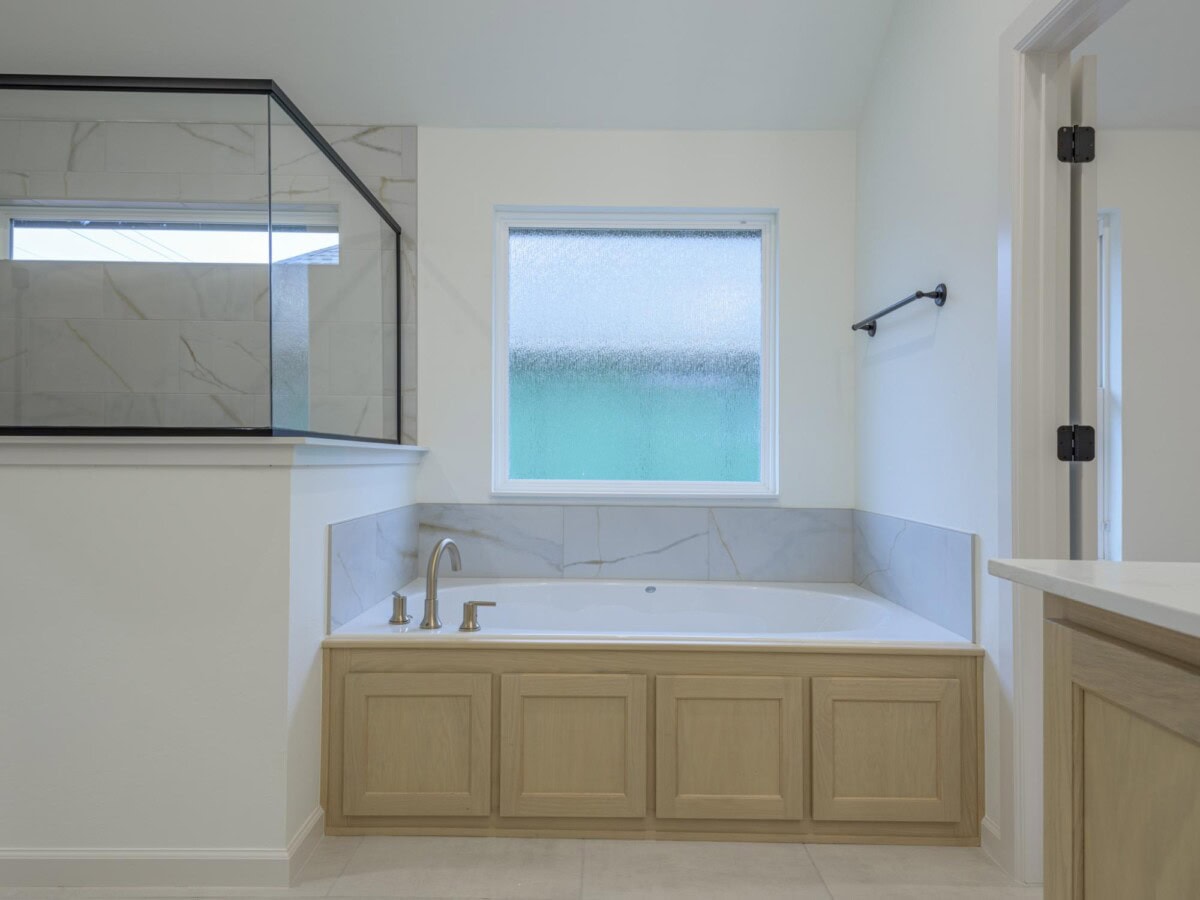 A bathroom with a tub and a sink