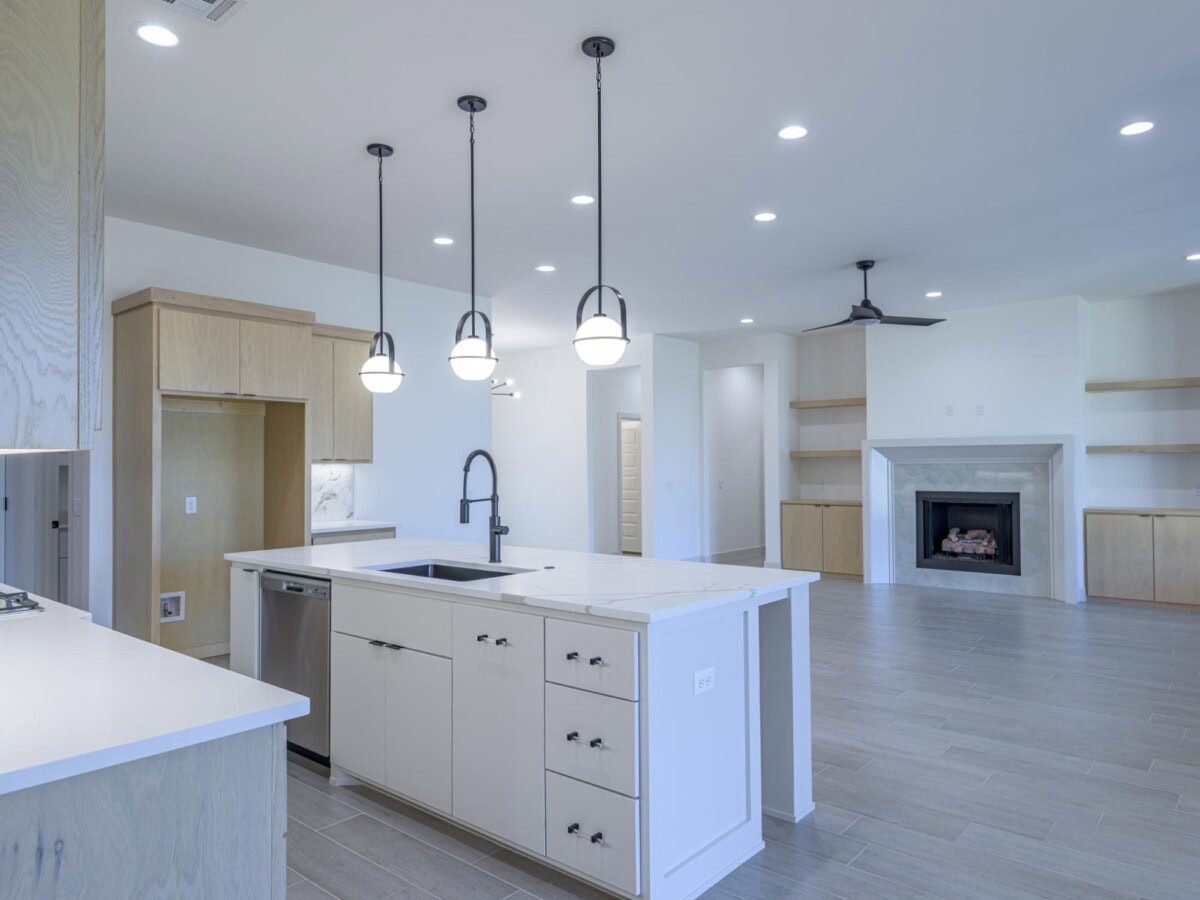 A kitchen with a white counter top and a stove