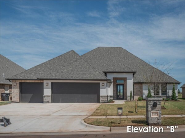 A home with a large garage and a large driveway