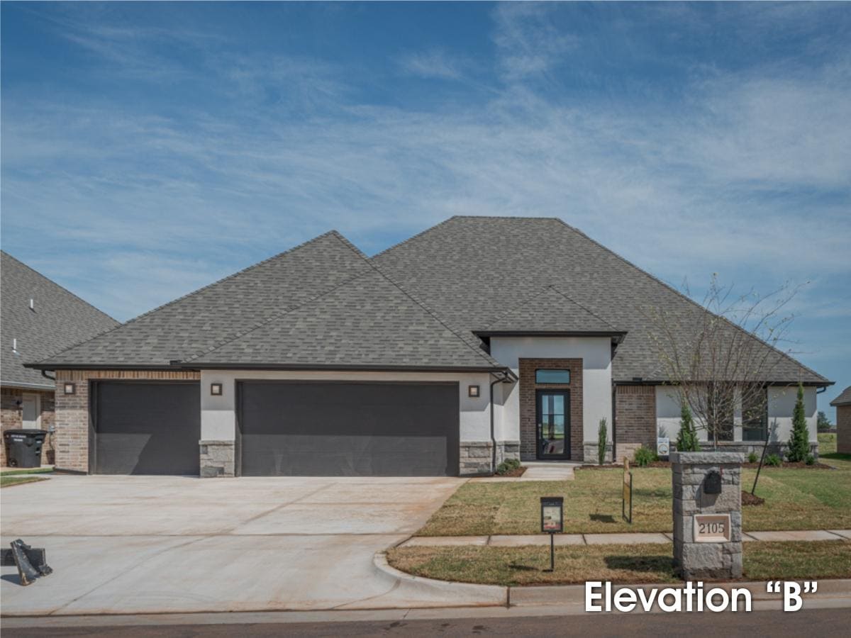 A home with a large garage and a large driveway