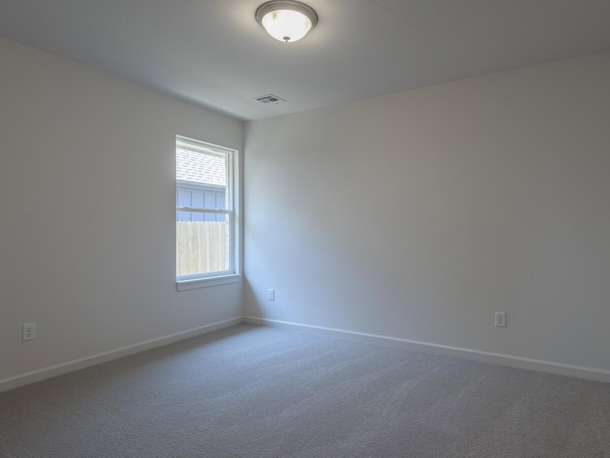 An empty room with a light and a window