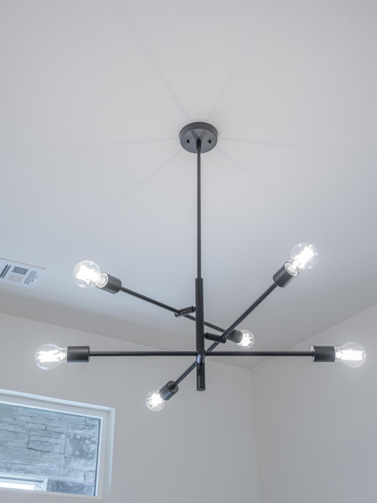 A modern chandelier with five lights in a room