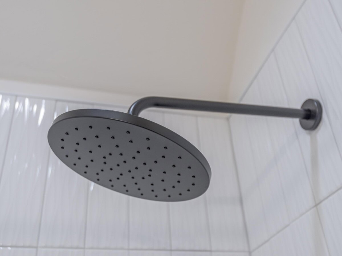 A shower head with a black handle and a black shower head