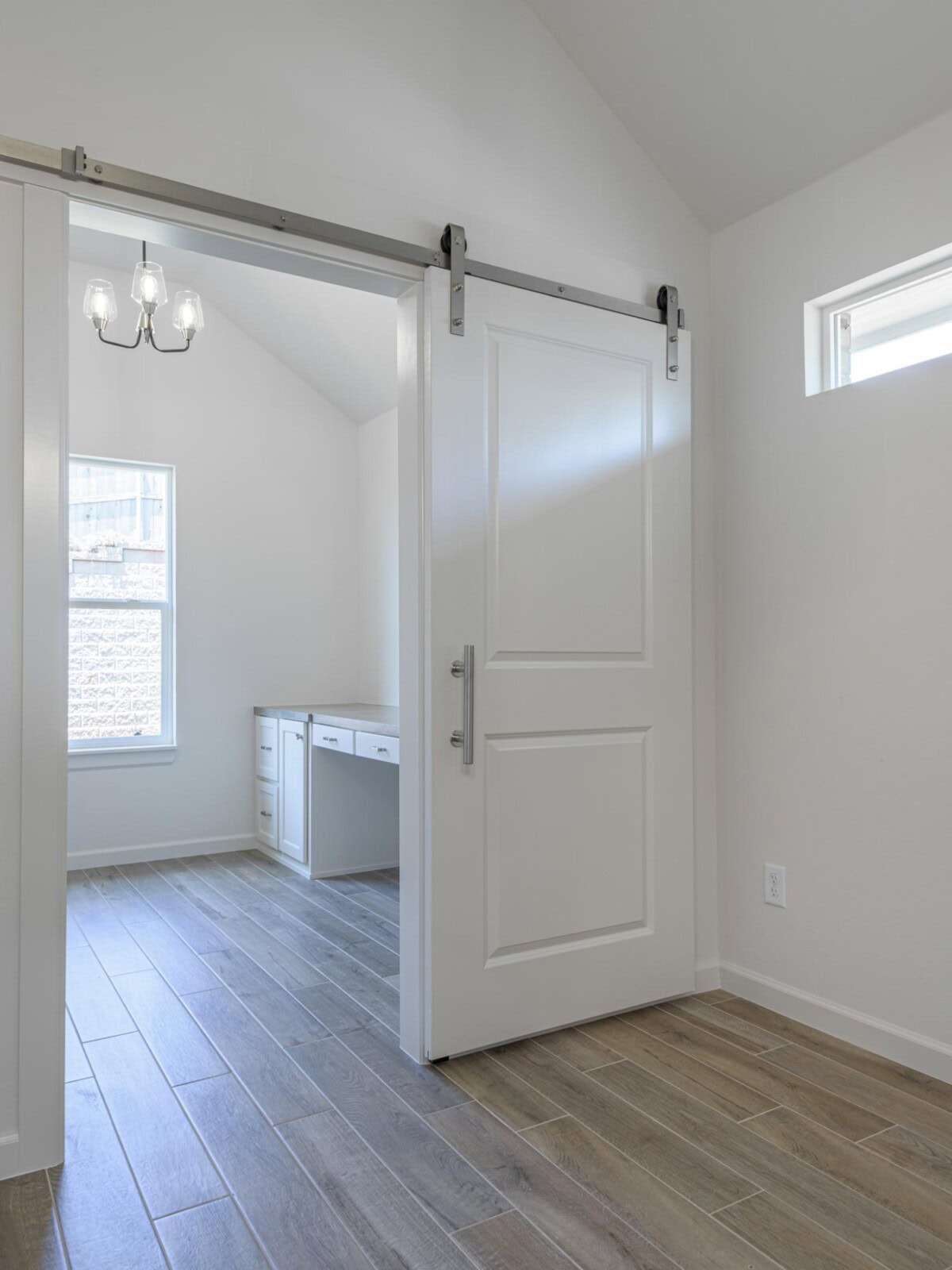 A white room with a sliding door and a desk