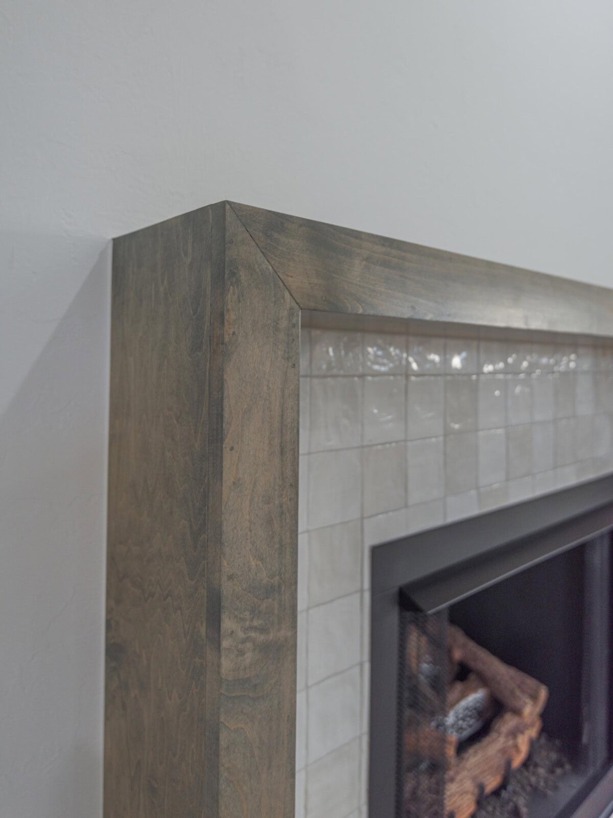 A fireplace with a mantle and a wood surround