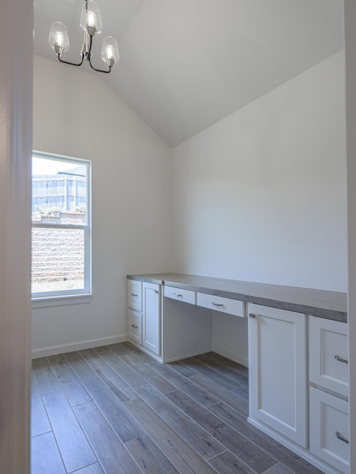 A white room with a desk and a window