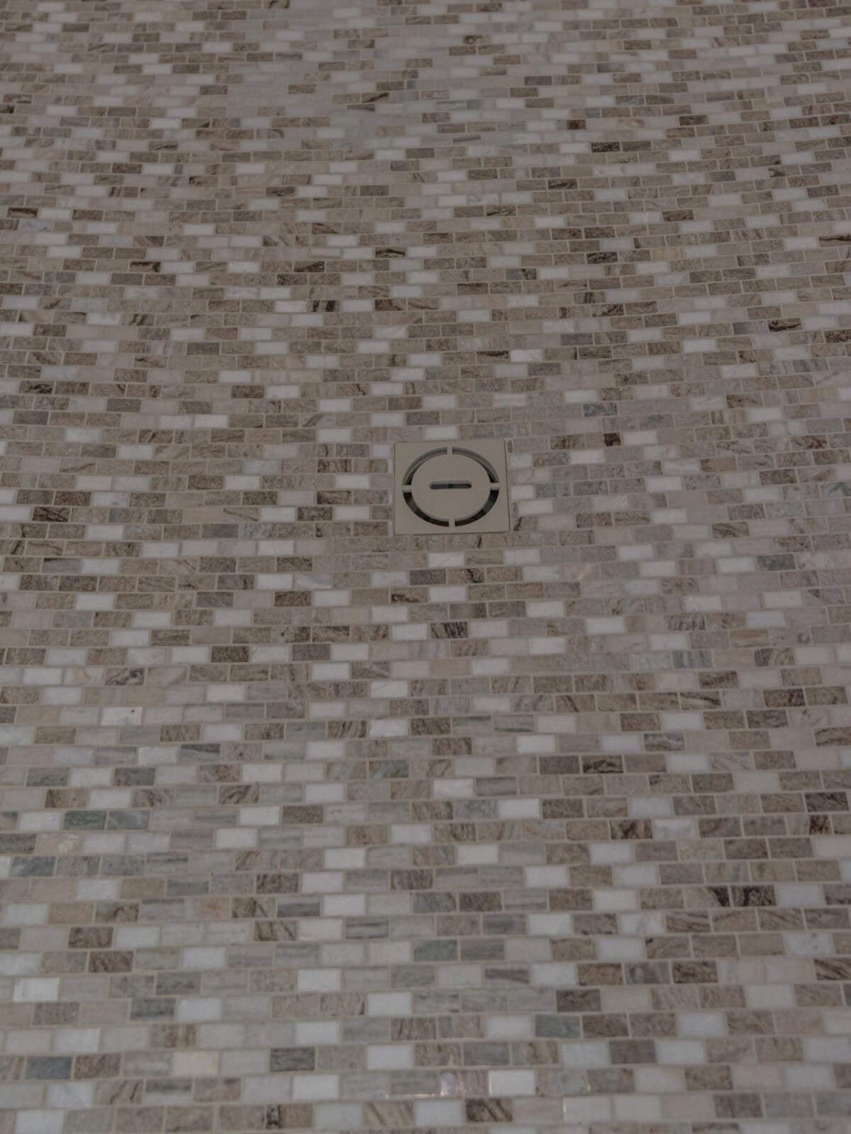 A shower with a drain in the middle of it