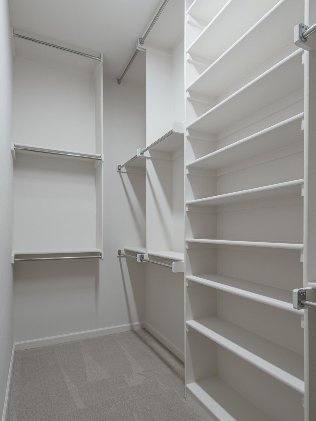 A walk in closet with shelves and shelves