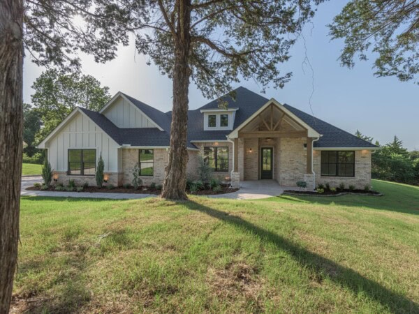 A home with a large front yard and trees