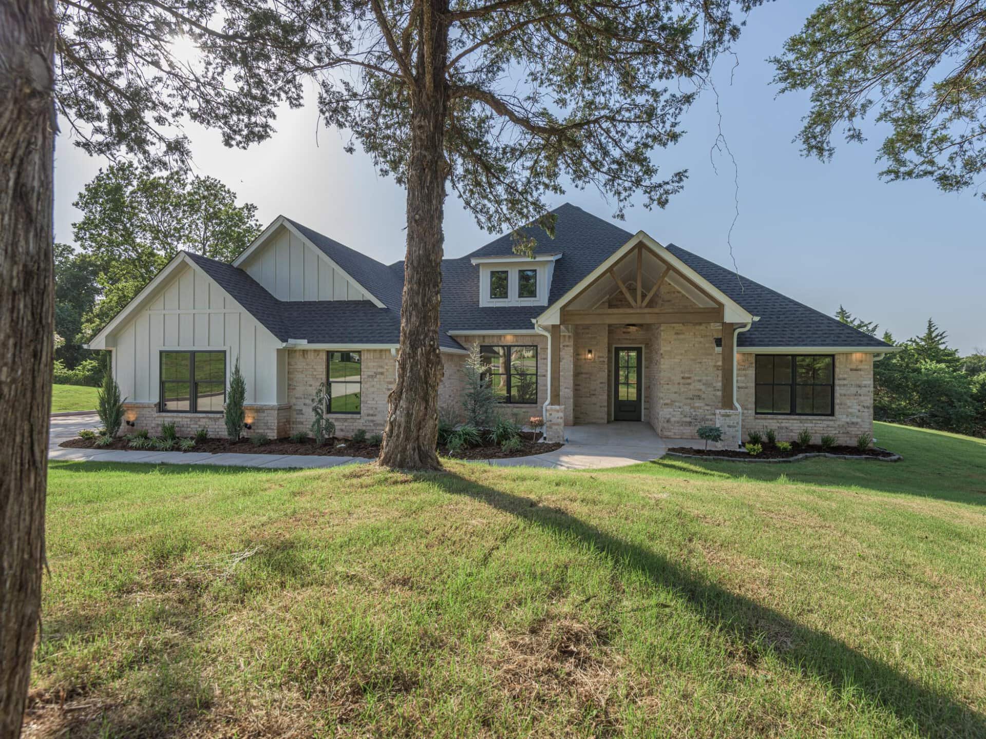 A home with a large front yard and trees