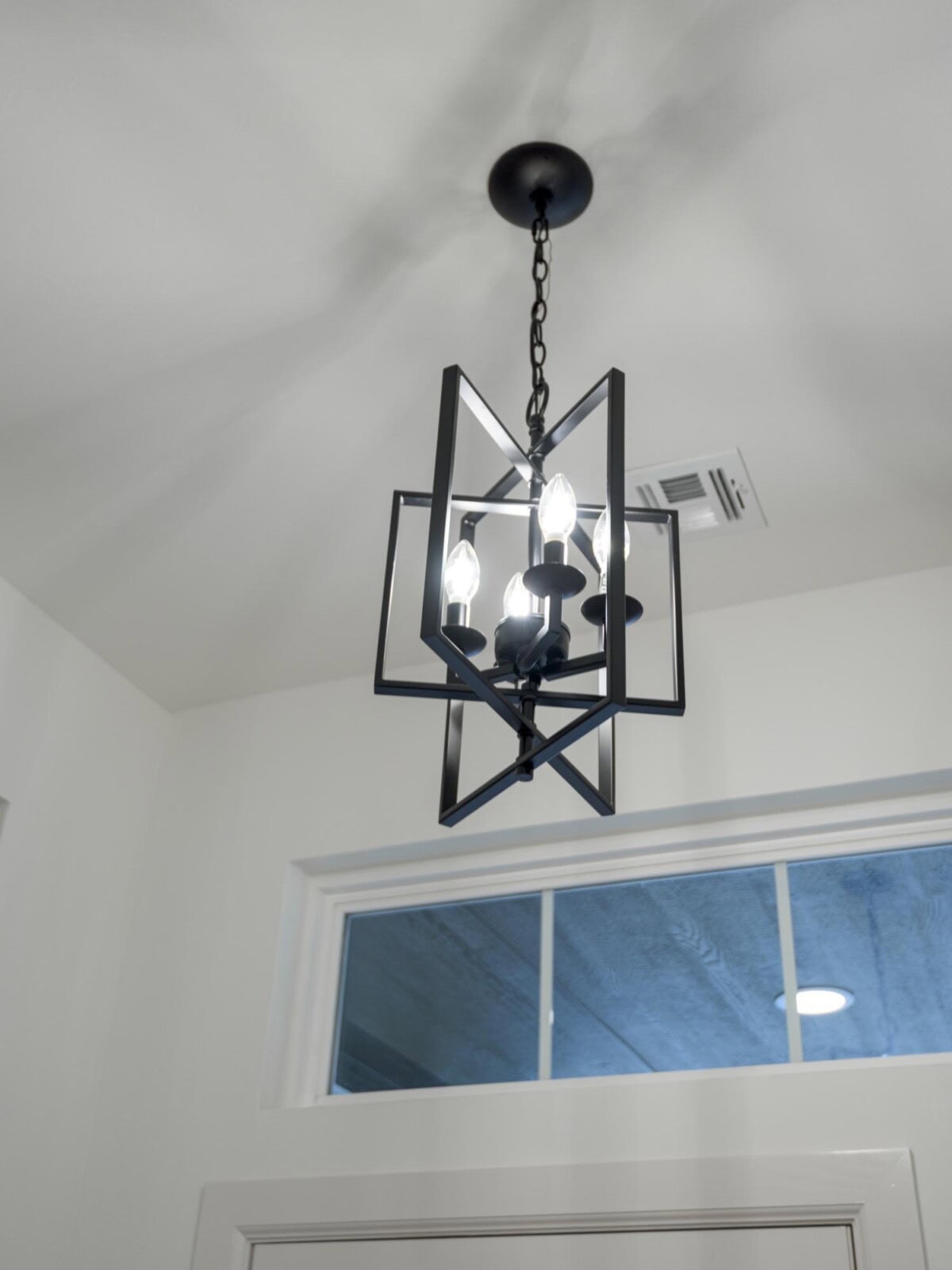 A chandelier hanging from the ceiling in a room