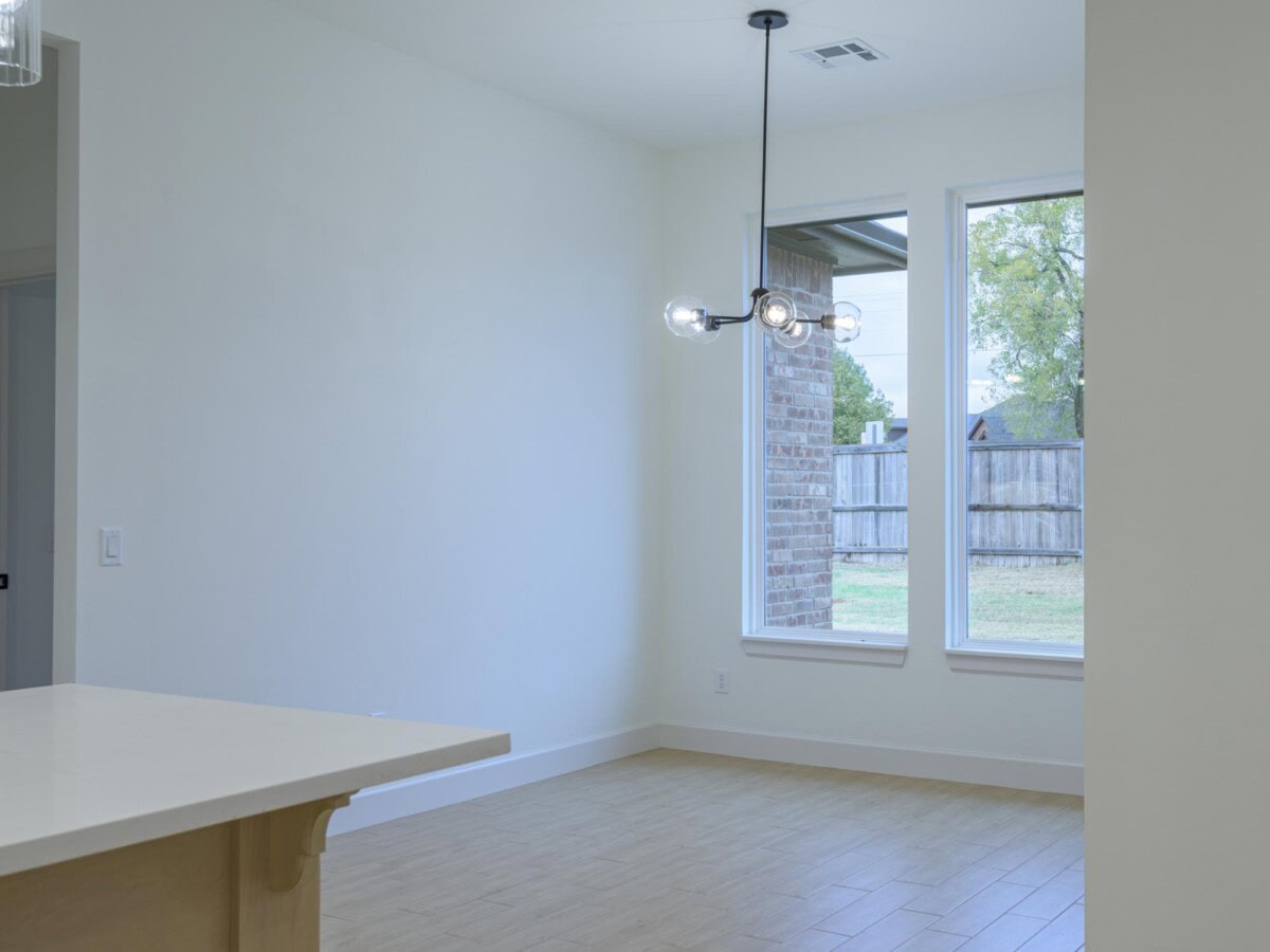 A kitchen with a large window and a counter