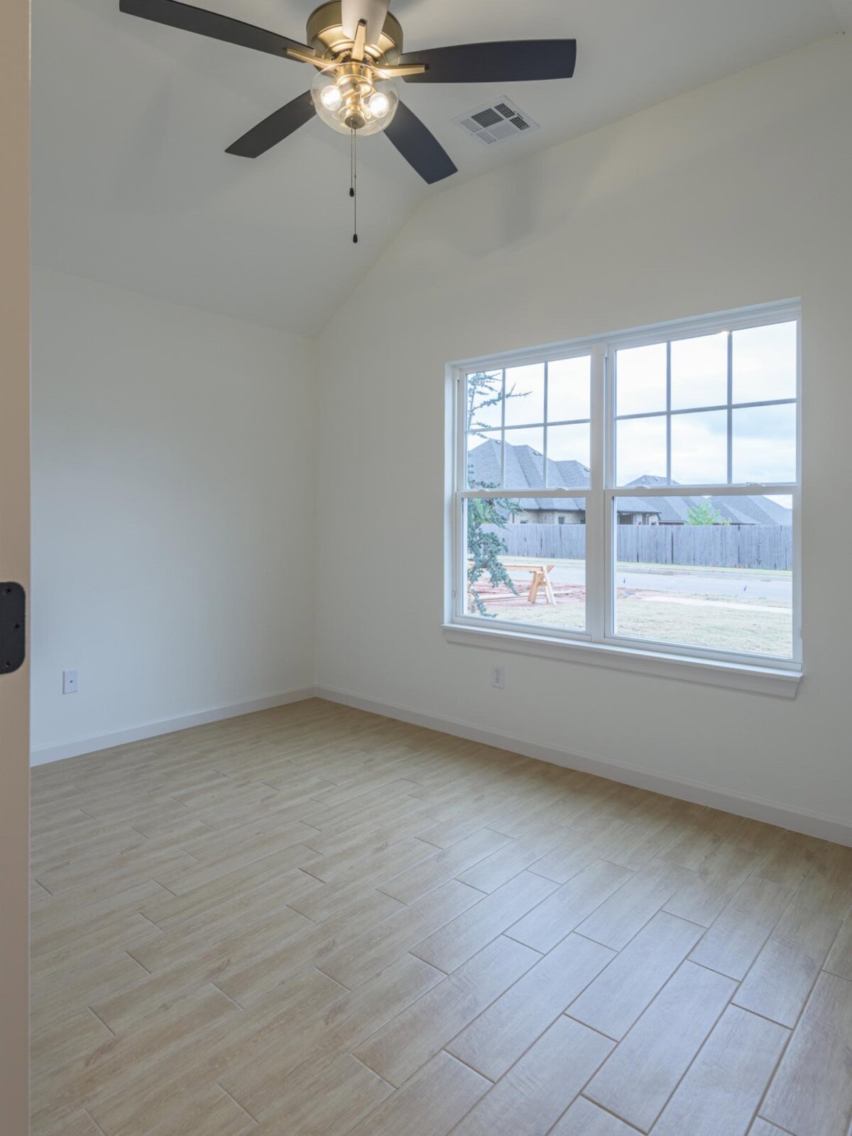 Empty room with ceiling fan and hardwood floors