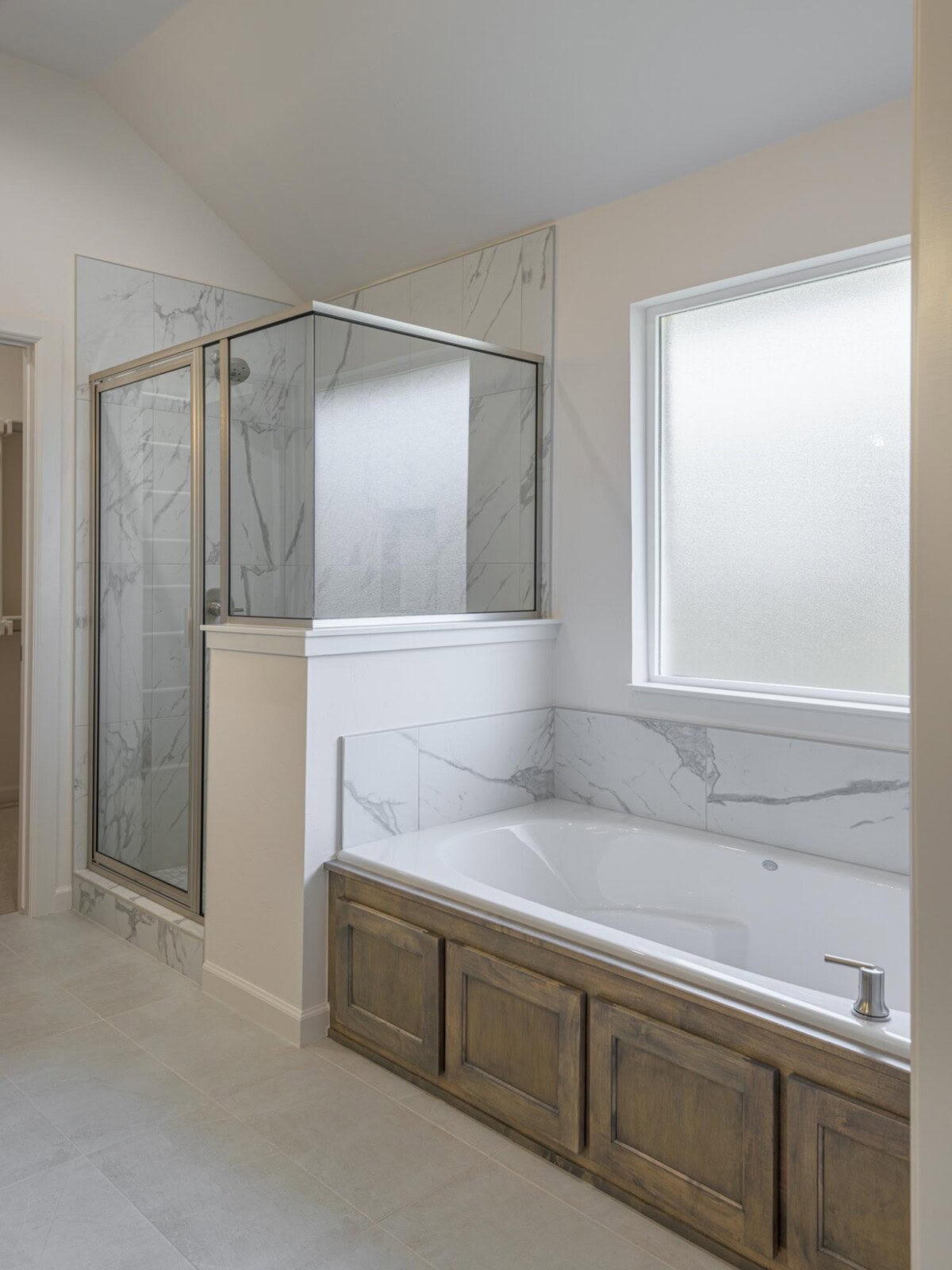 A bathroom with a tub and a shower