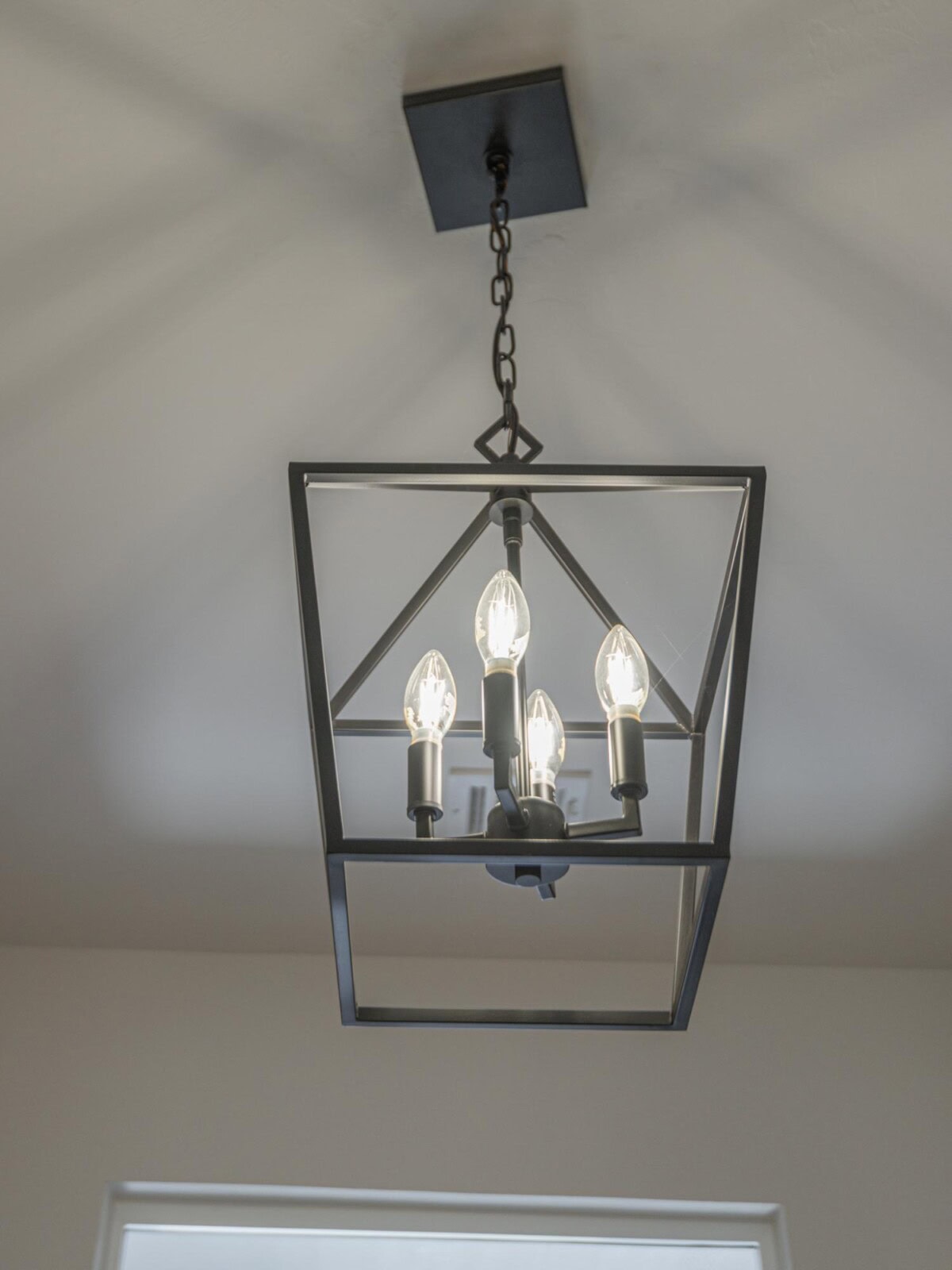 A black and white light fixture hanging from the ceiling