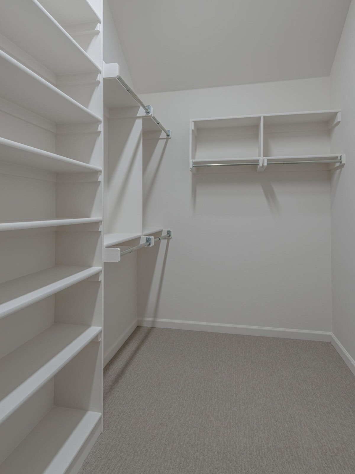 A walk in closet with shelves and shelves