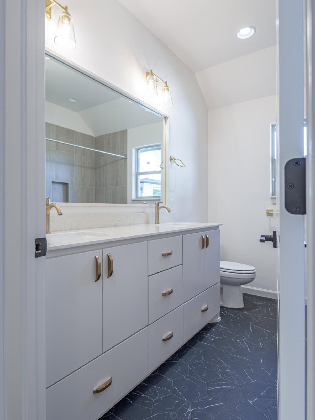 A bathroom with a large mirror and sink