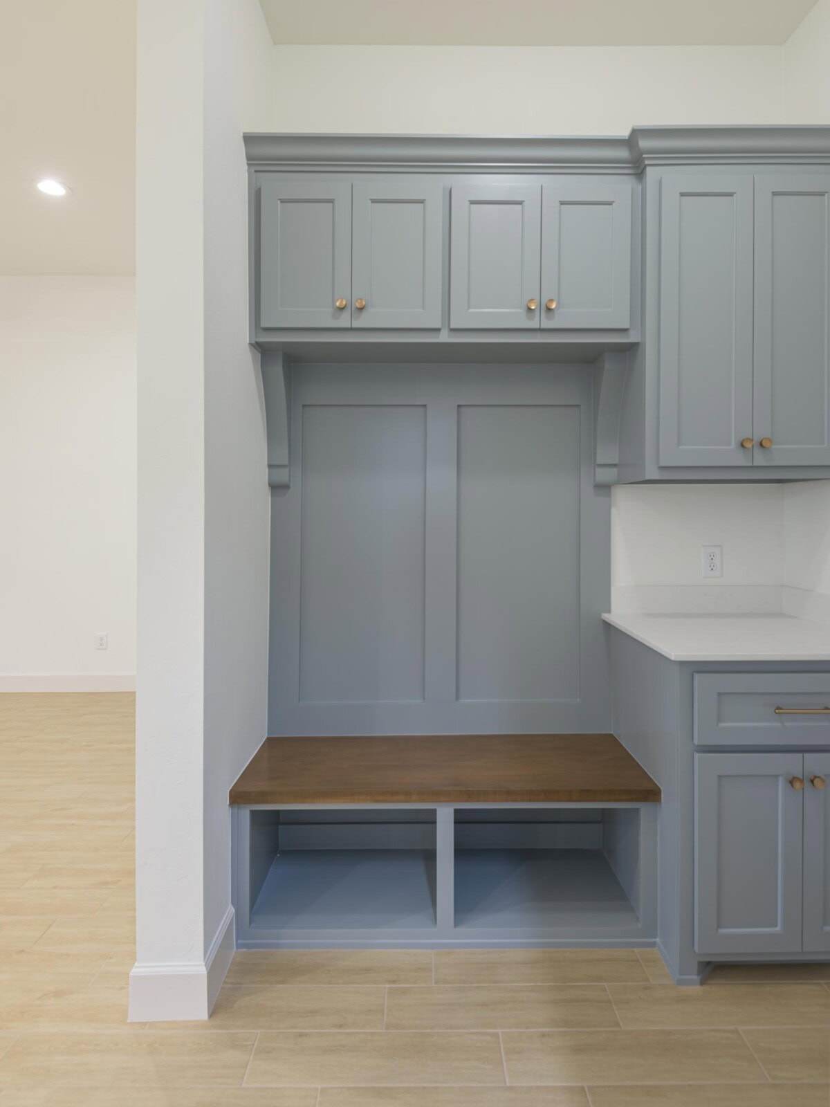 A kitchen with blue cabinets and a bench