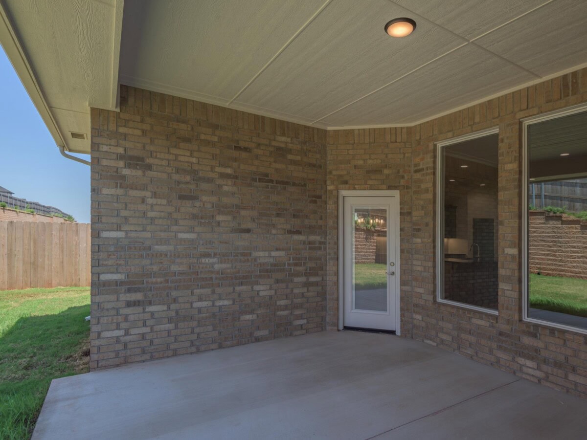 A brick patio with a sliding glass door