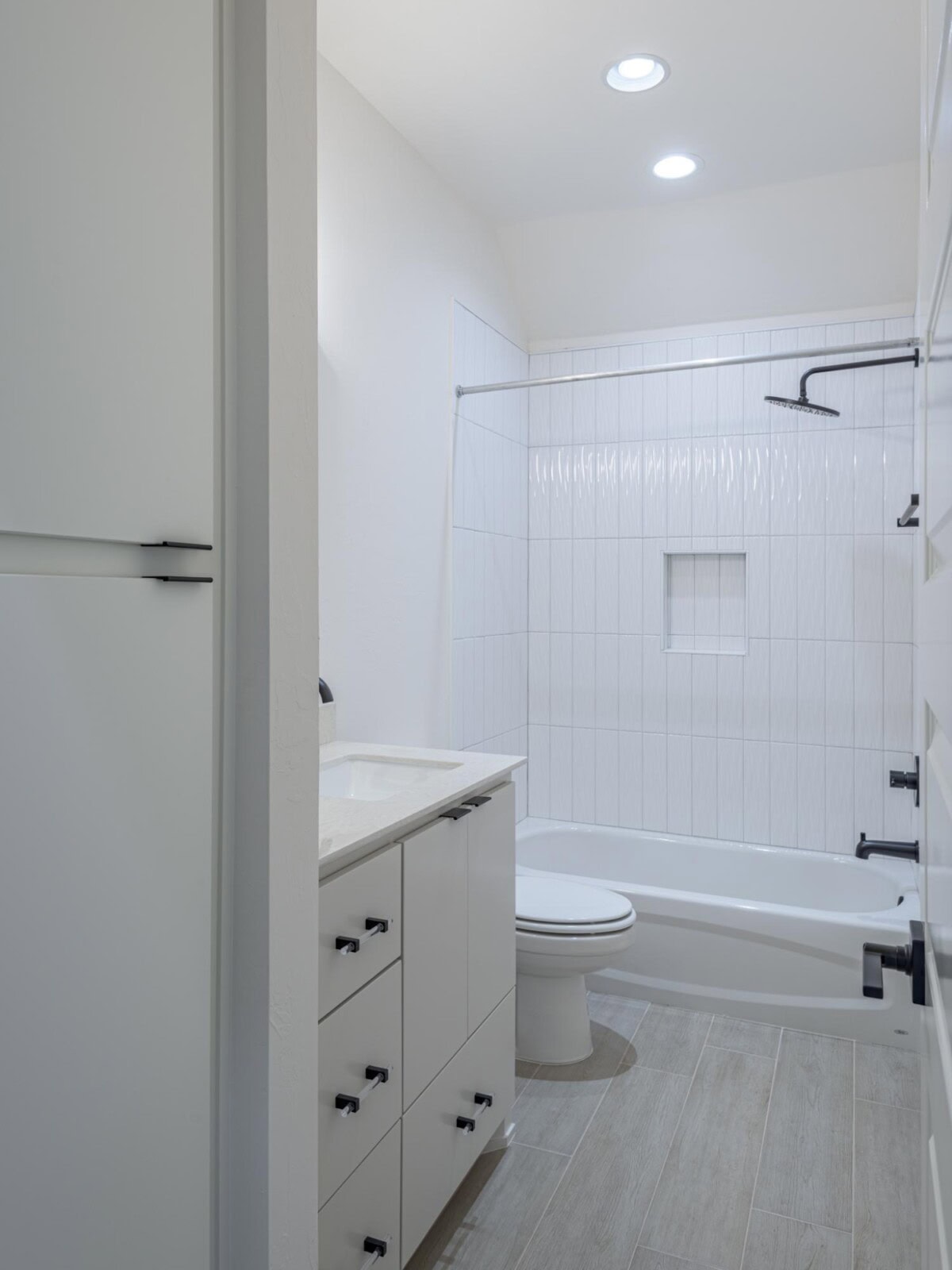 A bathroom with a toilet, sink and shower