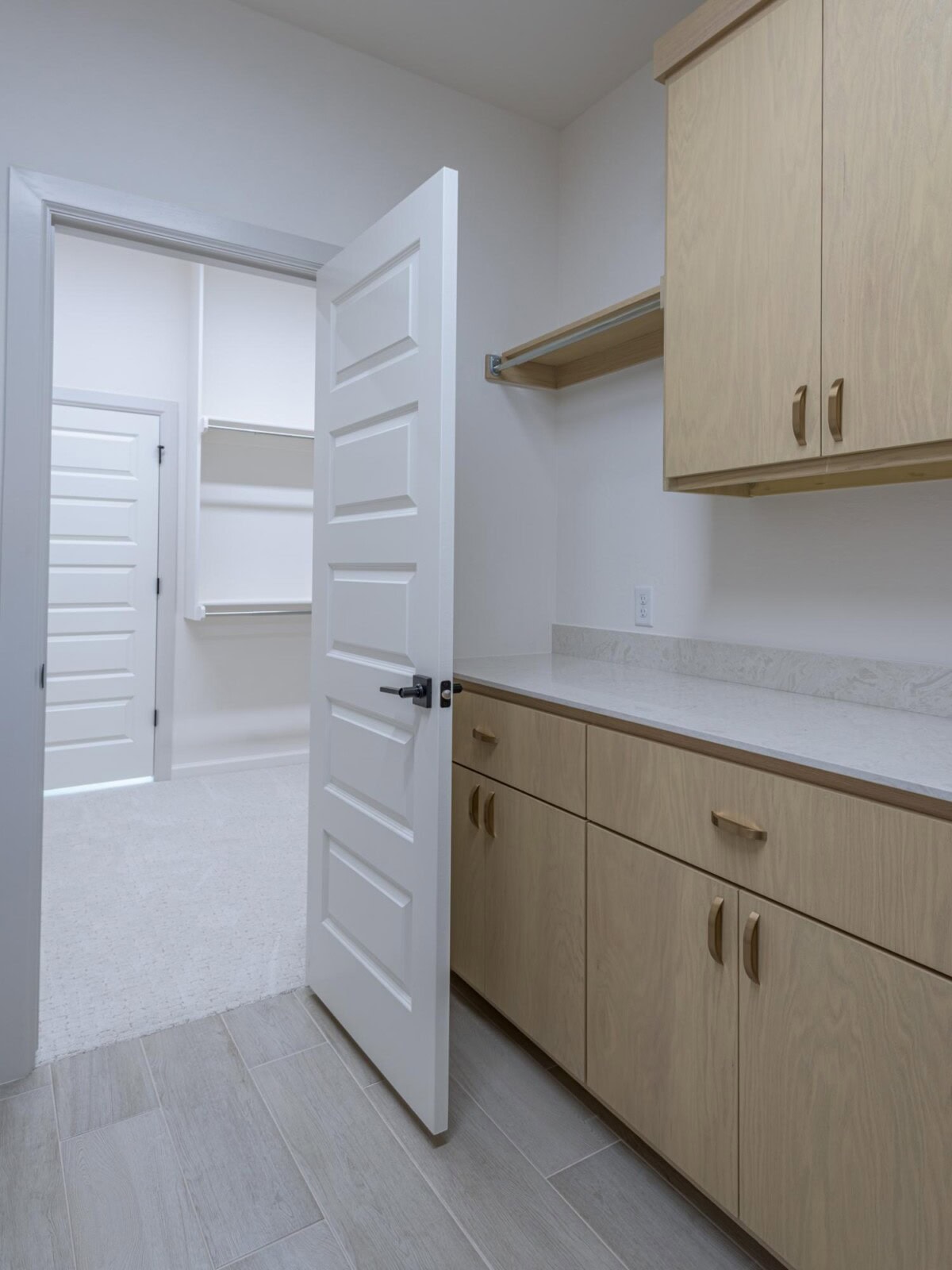 A kitchen with cabinets and a door